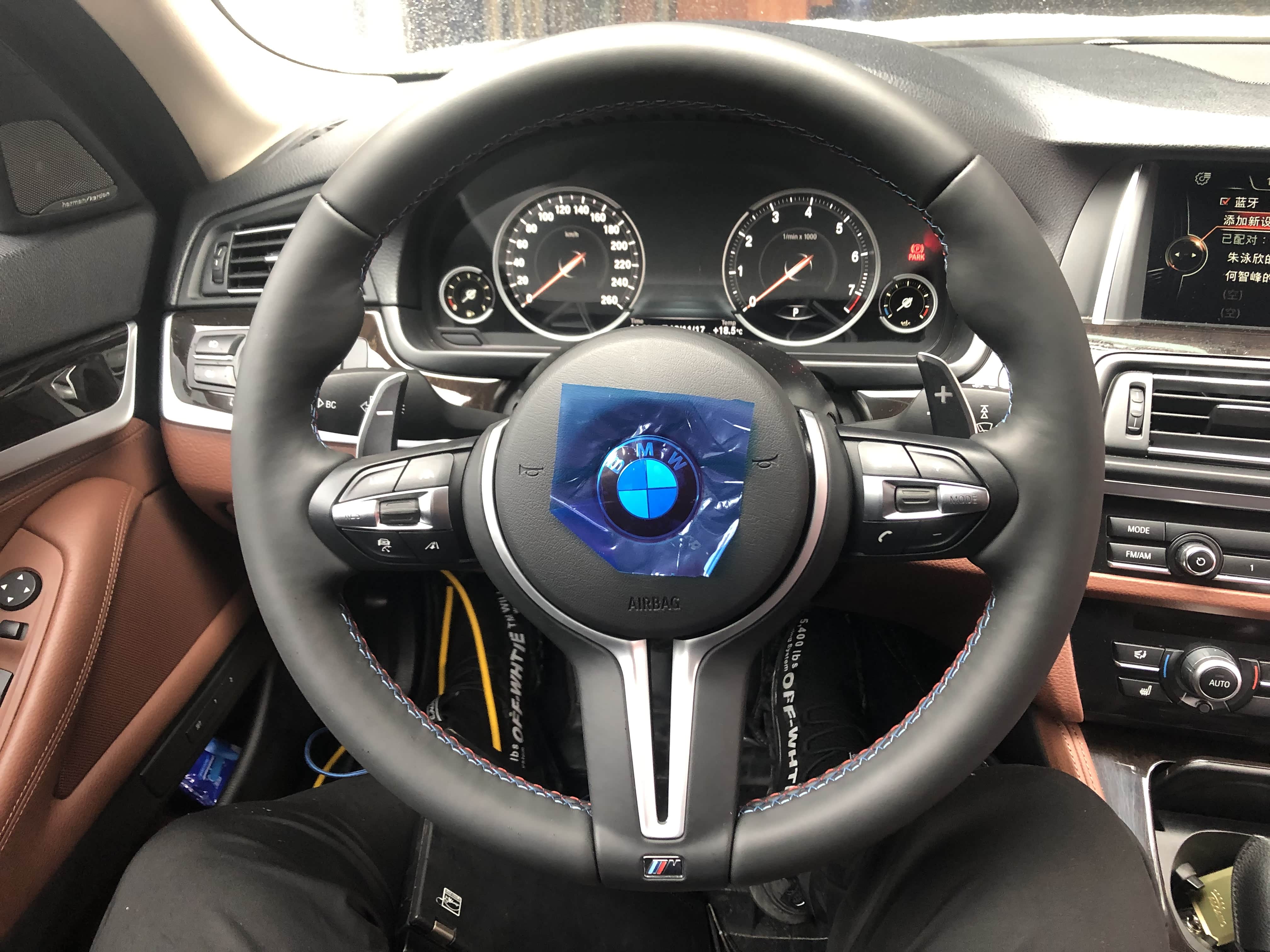 宝马m6方向盘采用红蓝白三色缝线,与m logo对应,还有换挡拨片,定速